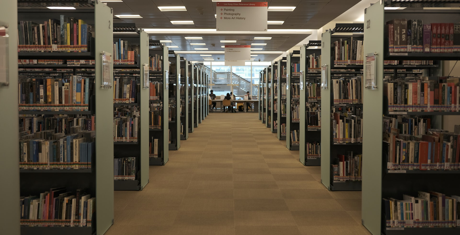 brown wooden bookshelves on brown floor tiles